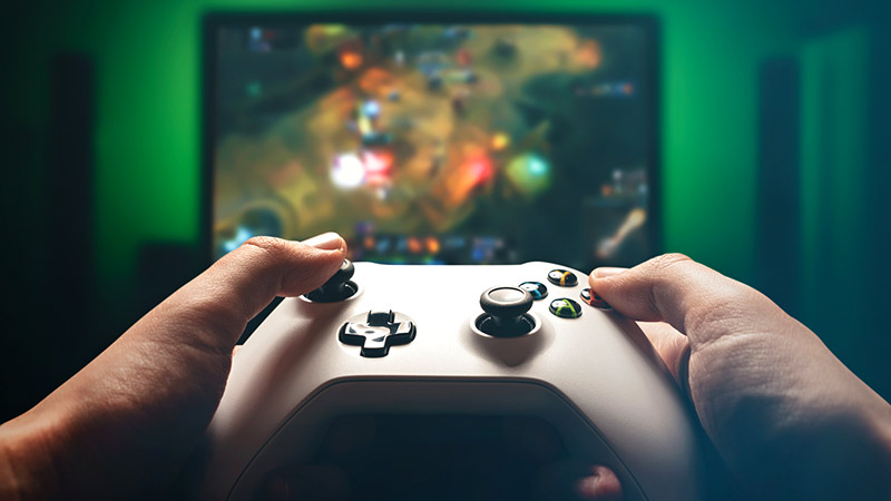 homme tenant une manette de jeu xbox 